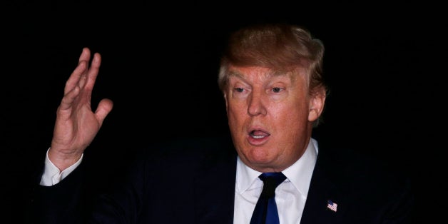 Republican presidential candidate, businessman Donald Trump gestures at a regional police union meeting in Portsmouth, N.H.,