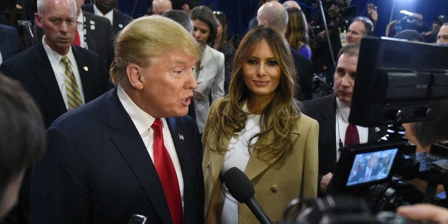 LAS VEGAS, NV - DECEMBER 15: Republican presidential candidate Donald Trump (L) and his wife Melania Trump talk to reporters