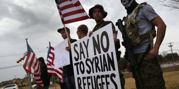 RICHARDSON, TX - DECEMBER 12: Armed protesters from the so-called Bureau of American-Islamic Relations (BAIR), take part in a demonstration in front of a mosque on December 12, 2015 in Richardson, Texas. About two dozen members of the group protested in front of the Islamic Association of North Texas mosque, as counter-protesters demonstrated across the street. The Dallas area had become a focal point for so-called Islamophobia, even before the Islamic extremist-inspired December 2 mass shooting in San Bernadino, California. (Photo by John Moore/Getty Images)