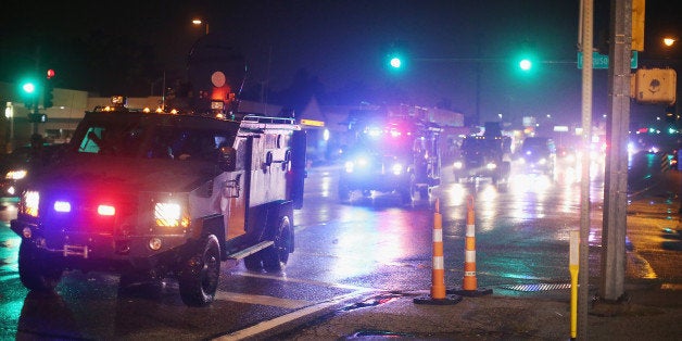 FERGUSON, MO - AUGUST 15: A convoy of armored personnel carriers (APC) carrying county police arrive after Missouri State Highway Patrol officers were taunted by demonstrators during a protest over the shooting of Michael Brown on August 15, 2014 in Ferguson, Missouri. As the taunts became more aggressive the troopers called in the county police then left the area. County police ended up shooting pepper spray, smoke, gas and flash grenades at protestors before retreating. Several businesses were looted as the county police watched from their APC parked nearby. Violent outbreaks have taken place in Ferguson since the shooting death of Brown by a Ferguson police officer on August 9. (Photo by Scott Olson/Getty Images)