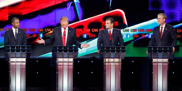 Donald Trump, second from left, makes a point as Ben Carson, left, Ted Cruz, second from right, and Jeb Bush look on during the CNN Republican presidential debate at the Venetian Hotel & Casino on Tuesday, Dec. 15, 2015, in Las Vegas. (AP Photo/John Locher)