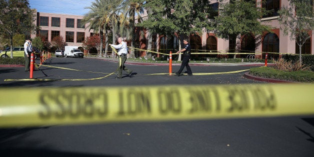 SAN BERNARDINO, CA - DECEMBER 07: Officials put up police tape in front of the builiding at the Inland Regional Center were