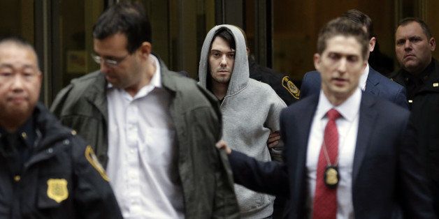 Martin Shkreli, chief executive officer of Turing Pharmaceuticals LLC, center, and attorney Evan Greebel, left, exit federal court in New York, U.S., on Thursday, Dec. 17, 2015. Shkreli was arrested on alleged securities fraud related to Retrophin Inc., a biotech firm he founded in 2011. Greebel is accused of conspiring with Shkreli in part of the scheme. Photographer: Peter Foley/Bloomberg via Getty Images 
