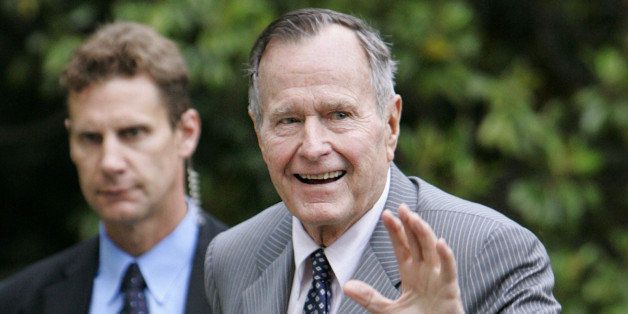 Former President George H.W. Bush waves as he arrives at the White House, Friday, May 19, 2006 in Washington. Former President Bush will be speaking at the commencement exercise at George Washington University on Sunday. Man on the left is unidentified Secret Service agent. (AP Photo/Manuel Balce Ceneta)