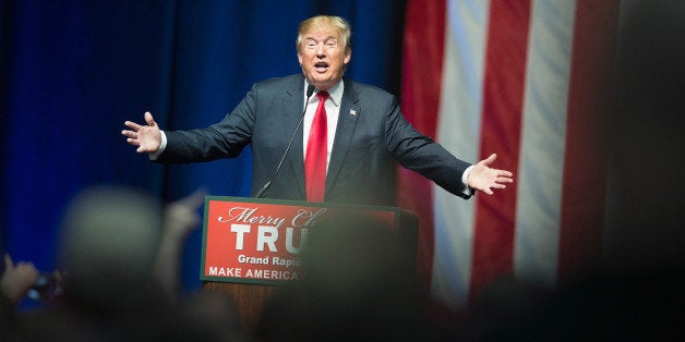 GRAND RAPIDS, MI - DECEMBER 21: Republican presidential candidate Donald Trump speaks to guests at a campaign rally on December 21, 2015 in Grand Rapids, Michigan. The full-house event was repeatedly interrupted by protestors. Trump continues to lead the most polls in the race for the Republican nomination for president. (Photo by Scott Olson/Getty Images)