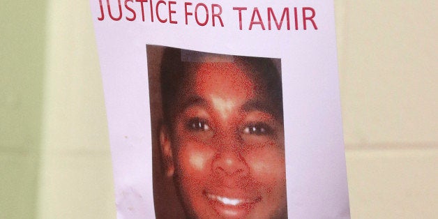 A person holds up a sign for justice for Tamir Rice during a news conference Monday, Dec. 8, 2014, in Cleveland. Samaria Rice