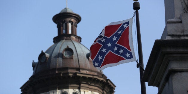 COLUMBIA, SC - JULY 09: The Confederate flag flies in front of the South Carolina statehouse for the last full day on July 9, 2015 in Columbia, South Carolina. South Carolina Governor Nikki Haley signed a bill to remove the Confederate flag from the statehouse grounds Friday morning. (Photo by John Moore/Getty Images)