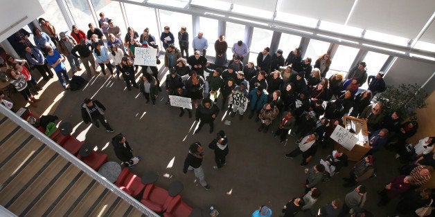 WALTHAM, MA - NOVEMBER 23: Brandeis University students, who are occupying the administration building and the president's office to protest the lack of diversity on campus, hold a short stand-in. They marched to The Heller School For Social Policy And Management, after hearing that a town-hall meeting was to be held regarding their actions, on Monday, Nov. 23, 2015. (Photo by Pat Greenhouse/The Boston Globe via Getty Images)