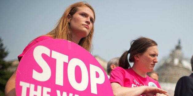 UNITED STATES - JUNE 10: From left, Charlotte Robertson, Rachel Clay, both of the Feminist Majority Foundation, and Rep. Lloyd Doggett, D-Texas, attend a news conference at the House triangle to to oppose 'fast tracking' of the Trans-Pacific Partnership (TPP) agreement and any future trade agreements, June 10, 2015. (Photo By Tom Williams/CQ Roll Call)