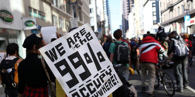 SAN FRANCISCO, CA - SEPTEMBER 17: An Occupy Wall Street protestor holds a sign during a demonstration on September 17, 2012