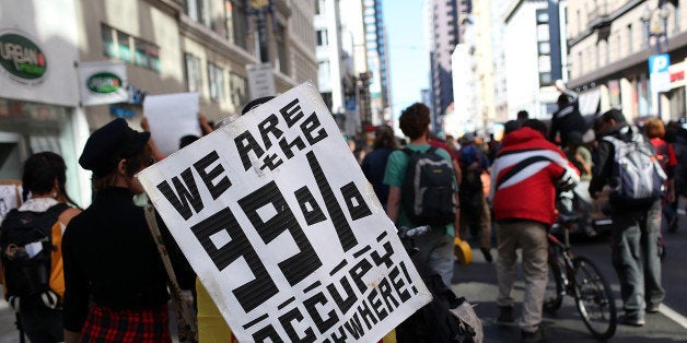 SAN FRANCISCO, CA - SEPTEMBER 17: An Occupy Wall Street protestor holds a sign during a demonstration on September 17, 2012 in San Francisco, California. An estimated 100 Occupy Wall Street protestors staged a demonstration and march through downtown San Francisco to mark the one year anniversary of the birth of the Occupy movement. (Photo by Justin Sullivan/Getty Images)