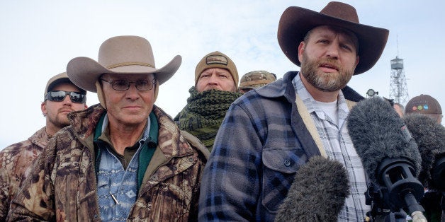 Ammon Bundy(R), leader of a group of armed anti-government protesters speaks to the media as other members look on at the Mal