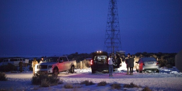 Members of a small militia at the entrance to the Malheur Wildlife Refuge Headquarters property some 30 miles from Burns, Oregon, January 3, 2016. The armed anti-government group have taken over a building at the federal wildlife refuge, accusing officials of unfairly punishing ranchers who refused to sell their land. The standoff has prompted some schools to call off classes for the entire week. AFP PHOTO / ROB KERR / AFP / ROB KERR (Photo credit should read ROB KERR/AFP/Getty Images)