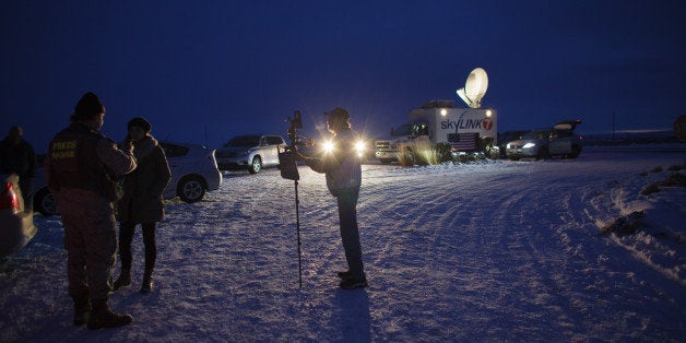 Media gather outside the entrance of the Malheur Wildlife Refuge Headquarters near Burns, Oregon, January 3, 2016, where an