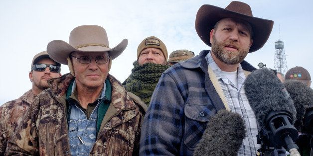 Ammon Bundy(R), leader of a group of armed anti-government protesters speaks to the media as other members look on at the Malheur National Wildlife Refuge near Burns, Oregon January 4, 2016. The FBI on January 4 sought a peaceful end to the occupation by armed anti-government militia members at a US federal wildlife reserve in rural Oregon, as the standoff entered its third day. The loose-knit band of farmers, ranchers and survivalists -- whose action was sparked by the jailing of two ranchers for arson -- said they would not rule out violence if authorities stormed the site, although federal officials said they hope to avoid bloodshed. AFP PHOTO / ROB KERR / AFP / ROB KERR (Photo credit should read ROB KERR/AFP/Getty Images)