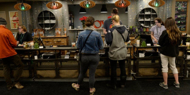 MANITOU SPRINGS, CO - December 09: Customers at Emerald Fields retail marijuana shop at the customer counter December 09, 2015. Photo by Andy Cross/The Denver Post via Getty Images