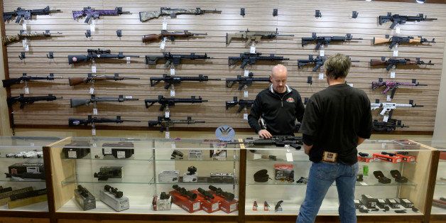 LAKEWOOD, CO - January 05: Bristlecone Shooting, Training and Retail Center customer service representative Steve MacGregor, left, shows customer Charles Wenger several rifles at the shop January 05, 2015. (Photo by Andy Cross/The Denver Post via Getty Images)