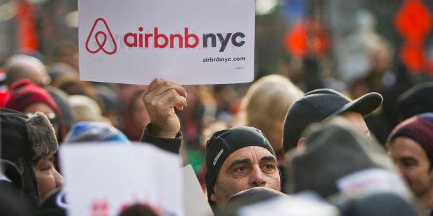 Supporters of Airbnb hold a rally outside City Hall, Tuesday, Jan. 20, 2015, in New York. With home-as-hotel sites like Airbnb doing booming business, New York City lawmakers are holding a hearing to scrutinizing how the trend affects the housing market and economy. (AP Photo/Bebeto Matthews)