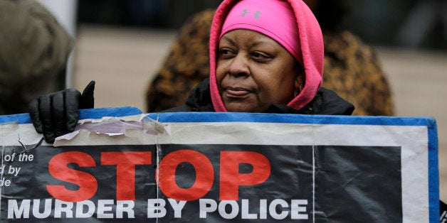 Loria Edwards protests outside the Cuyahoga County Justice Center, Tuesday, Dec. 29, 2015, in Cleveland. People marched peacefully in front of the Justice Center in downtown Cleveland to protest a grand jury's decision not to indict two white Cleveland police officers in the fatal shooting of Tamir Rice, a black 12-year-old boy who was playing with a pellet gun. (AP Photo/Tony Dejak)