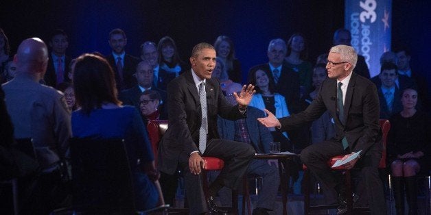 US President Barack Obama speaks at a town hall meeting with CNN's Anderson Cooper (R) on reducing gun violence at George Mason University in Fairfax, Virginia, on January 7, 2016. Obama announced limited measures two days ago to tackle rampant US gun violence and called on Americans to punish lawmakers who oppose more meaningful reforms. AFP PHOTO/NICHOLAS KAMM / AFP / NICHOLAS KAMM (Photo credit should read NICHOLAS KAMM/AFP/Getty Images)