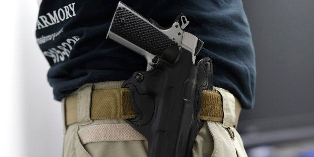 Mike Weinstein, director of training and security at the National Armory gun store and gun range, has a Ruger 1911hand gun in a holster as he teaches a Concealed Weapons Permit class, Tuesday, Jan. 5, 2016, in Pompano Beach, Fla. President Barack Obama unveiled his plan Tuesday to tighten control and enforcement of firearms in the U.S. (AP Photo/Lynne Sladky)