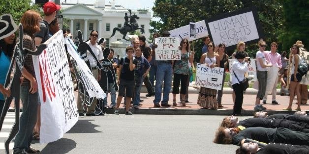 Protesters block street to disrupt business as usual as Obama meets with Uribe.