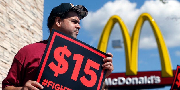 Supporters of a $15 minimum wage for fast food workers rally in front of a McDonald's on Wednesday, July 22, 2015, in Albany, N.Y. (AP Photo/Mike Groll)