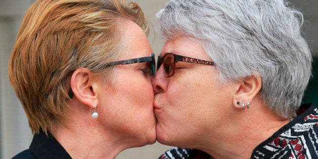 FILE- In this Feb. 19, 2015, file photo, Marj Plumb, right, and Tracy Weitz, one of seven same-sex couples who had sued to bl