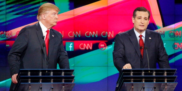 Ted Cruz, right, speaks as Donald Trump looks on during the CNN Republican presidential debate at the Venetian Hotel & Casino on Tuesday, Dec. 15, 2015, in Las Vegas. (AP Photo/John Locher)