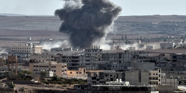 Smoke rises from an airstrike in the Syrian town of Ain al-Arab, known as Kobane by the Kurds, as seen from the Turkish-Syrian border, in the southeastern village of Mursitpinar, Sanliurfa province, on October 9, 2014. Kurdish fighters appeared to control most of the Syrian border town of Kobane Thursday amid continued US air strikes on Islamic State jihadists, the US military said.AFP PHOTO / ARIS MESSINIS (Photo credit should read ARIS MESSINIS/AFP/Getty Images)