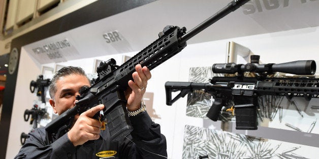 LAS VEGAS, NV - JANUARY 19: Glen Kukula checks out a Patrol SIG716 rifle by Sig Sauer at the 2016 National Shooting Sports Foundation's Shooting, Hunting, Outdoor Trade (SHOT) Show at the Sands Expo and Convention Center on January 19, 2016 in Las Vegas, Nevada. The SHOT Show, the world's largest annual trade show for shooting, hunting and law enforcement professionals, runs through January 23 and is expected to feature 1,600 exhibitors showing off their latest products and services to more than 62,000 attendees. (Photo by Ethan Miller/Getty Images)