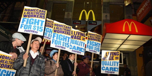 BROOKLYN, NEW YORK CITY, UNITED STATES - 2015/11/10: Home health activist with signs array in front of downtown Brooklyn McDonald's. Fight for Fifteen's national day of action began with a walk-out of fast food employees and a rally in downtown Brooklyn where mayor de Blasio and other leaders spoke. (Photo by Andy Katz/Pacific Press/LightRocket via Getty Images)