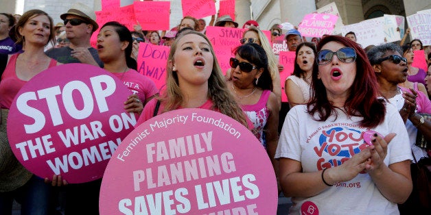 FILE - In this Sept. 9, 2015, file photo, Planned Parenthood supporters rally for women's access to reproductive health care on "National Pink Out Day'' at Los Angeles City Hall. With a deeper-than-ever split between Republicans and Democrats over abortion, activists on both sides of the debate foresee a 2016 presidential campaign in which the nominees tackle the volatile topic more aggressively than in past elections. (AP Photo/Nick Ut, File)