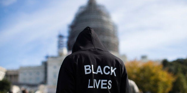 Neal Blair, of Augusta, Ga., wears a hoodie which reads, "Black Lives Matter" as stands on the lawn of the Capitol building during a rally to mark the 20th anniversary of the Million Man March, on Capitol Hill, on Saturday, Oct. 10, 2015, in Washington. Black men from around the nation returned to the capital calling for changes in policing and in black communities. (AP Photo/Evan Vucci)