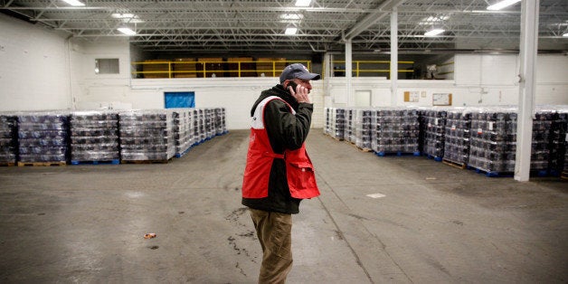 FLINT, MI - JANUARY 21: American Red Cross volunteer John Lohrstorfer in the warehouse full of water bottles for Flint residents on January 21, 2016 in Flint, Michigan. The Red Cross is supporting state and county efforts to bring water to every household in the city. (Photo by Sarah Rice/Getty Images)