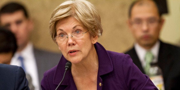 Sen. Elizabeth Warren, D-Mass., speaks to a conference as House and Senate negotiators try to resolve competing versions of a