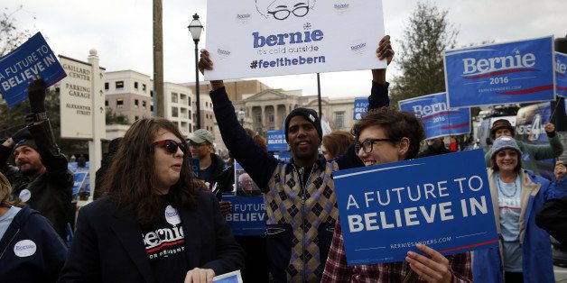 Supporters of Senator Bernie Sanders, an independent from Vermont and 2016 Democratic presidential candidate, not pictured, cheer before the Democratic presidential candidate debate in Charleston, South Carolina, U.S., on Sunday, Jan. 17, 2016. Hours before Sundays Democratic debate, the two top Democratic contenders held a warm-up bout of sorts in multiple separate appearances on political talk shows, at a time when the polling gap between the pair has narrowed in early-voting states. Photographer: Patrick T. Fallon/Bloomberg via Getty Images
