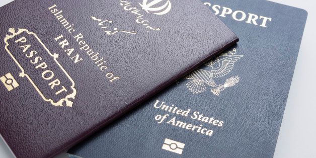 U.S. passport with an Iranian passport on a white background