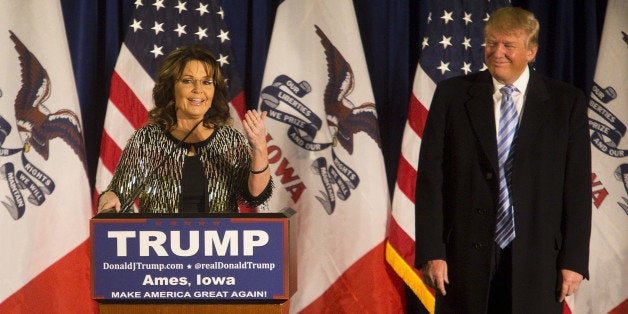 Sarah Palin, former governor of Alaska, left, speaks as Donald Trump, president and chief executive of Trump Organization Inc. and 2016 Republican presidential candidate, listens during a campaign rally at the Hansen Agricultural Student Learning Center at Iowa State University in Ames, Iowa, U.S., on Tuesday, Jan. 19, 2016. Trump's campaign to win the Iowa caucuses in less than two weeks received a boost from a Tea Party favorite, Sarah Palin. Photographer: Cassi Alexandra/Bloomberg via Getty Images 