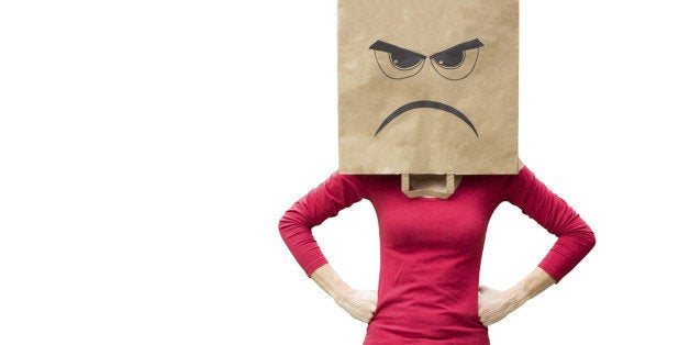 Woman with paper bag on her head with an angry expression on it