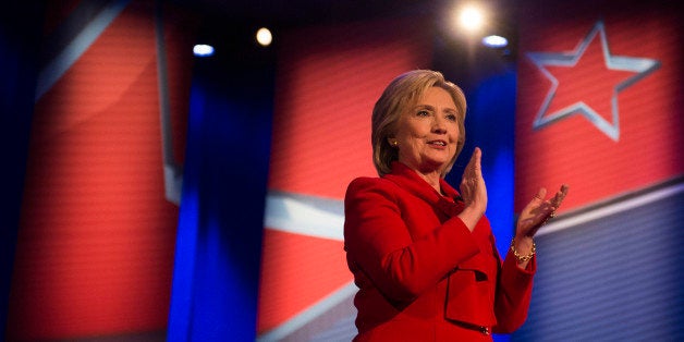 Democratic presidential candidate Hillary Clinton applauds during the CNN Town Hall at Drake University in Des Moines , Iowa, January 25, 2016, ahead of the Iowa Caucus. AFP PHOTO / JIM WATSON / AFP / JIM WATSON (Photo credit should read JIM WATSON/AFP/Getty Images)