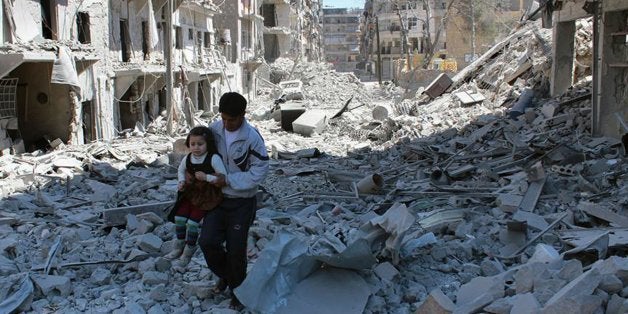 FILE -- In This April 21, 2014, file photo, provided by the anti-government activist group Aleppo Media Center (AMC), which has been authenticated based on its contents and other AP reporting, shows a Syrian man holding a girl as he stands on the rubble of houses that were destroyed by Syrian government forces air strikes in Aleppo, Syria. Nearly four years since it began, Syriaâs civil war has defied all diplomatic attempts to broker a peaceful resolution _ and the fierce fighting still goes on daily, though it has taken a back seat to the rampage in the region by Islamic State militants. (AP Photo/Aleppo Media Center AMC, File)