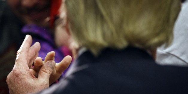 A child reaches out to shake hands with Donald Trump, president and chief executive of Trump Organization Inc. and 2016 Repub