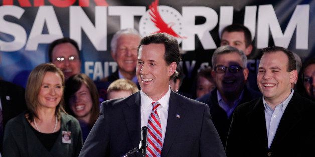 Republican presidential candidate, former Pennsylvania Sen. Rick Santorum, joined by wife Karen, left, addresses supporters at his Iowa caucus victory party Tuesday, Jan. 3, 2012, in Johnston, Iowa. (AP Photo/Charlie Riedel)