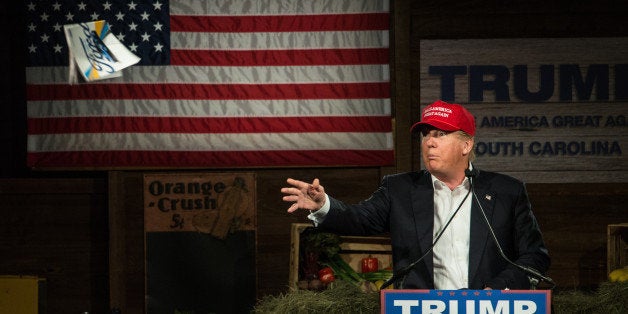 GILBERT, SC - JANUARY 27: GOP presidential candidate Donald Trump throws an issue of Time Magazine into the crowd at a campaign rally January 27, 2015 in Gilbert, South Carolina. Trump is leading in the polls among the GOP presidential candidates leading up to the Iowa Caucus. (Photo by Sean Rayford/Getty Images)