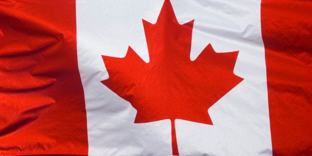 Close up of Canadian flag, in blue sky.