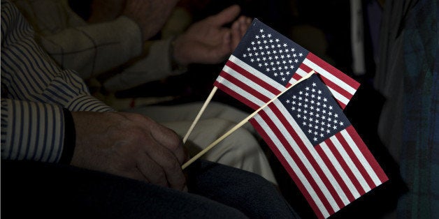 An attendee holds American flags as Senator Bernie Sanders, an independent from Vermont and 2016 Democratic presidential cand