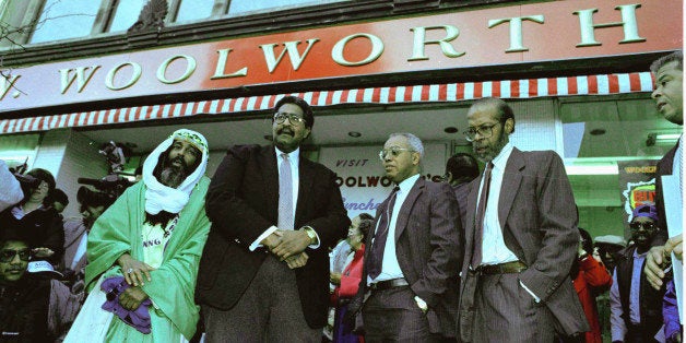 Four men who 34 years ago were denied service at a Woolworth store in Greensboro, N.C., pause in front of the store, Feb. 1,