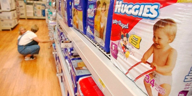 ** FILE ** In a file photo a shopper and her child look at diapers at a Little Rock, Ark., Wal-Mart Super Center store Wednesday, Aug. 24, 2004. Kimberly-Clark Corp., the world's top maker of personal paper products including Kleenex and Huggies diapers, said Monday, Oct. 24, 2005, its third-quarter profit fell 26 percent on charges related to streamlining its business, but results met Wall Street's expectations. (AP Photo/Danny Johnston)