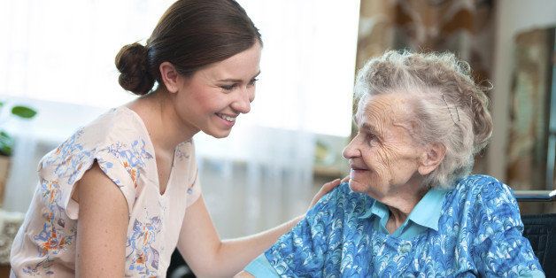 Elderly woman on wheelchair with a nurse